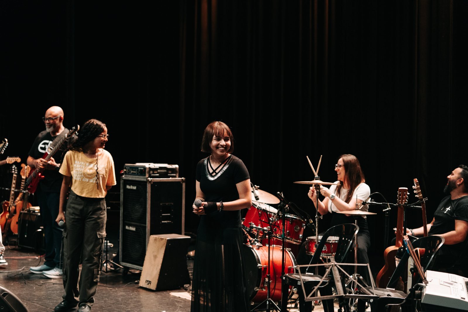 Mirian singing on stage with a live band
